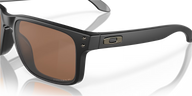 Black sunglasses with brown lenses on a reflective surface