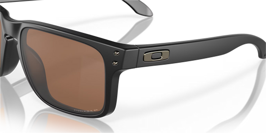 Black sunglasses with brown lenses on a reflective surface