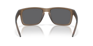 A pair of square-frame sunglasses with a translucent taupe-brown frame and dark gray lenses, shown from the front on a white background with a soft reflection.