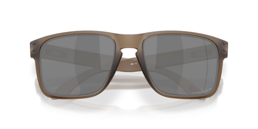 A pair of oversized square sunglasses with a translucent taupe-brown frame and dark gray lenses, shown from a front-facing perspective on a clean white background.