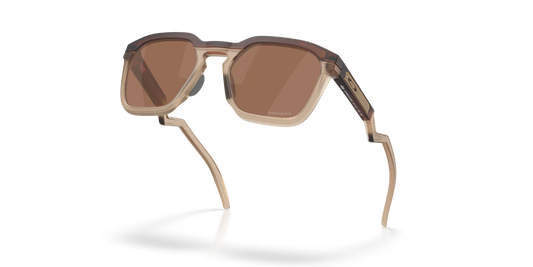 Sunglasses with brown lenses and beige frame on a white background