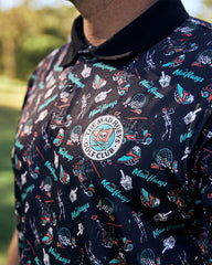 Close-up of a patterned shirt with a logo and text, set against a blurred outdoor background.