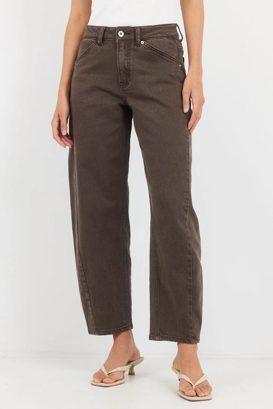 Brown jeans worn by a person on a white background