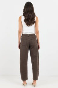 Woman wearing brown pants and a white top on a white background