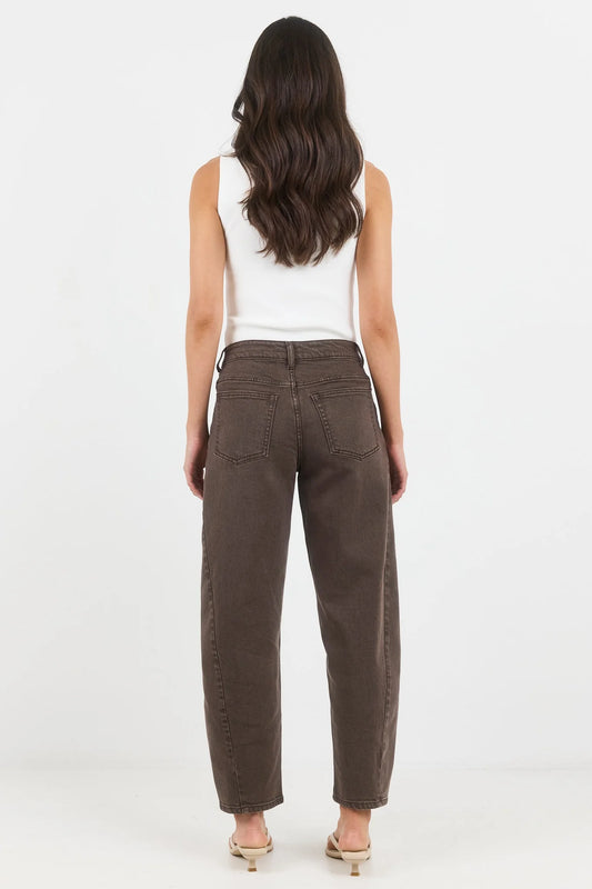 Woman wearing brown pants and a white top on a white background