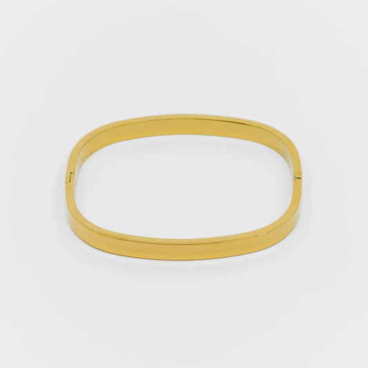 Gold bangle on a white background