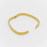 Gold bracelet on a white background
