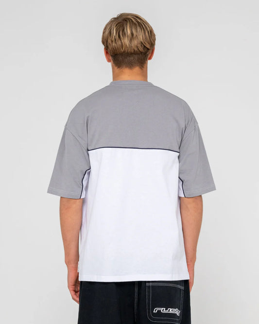 Person wearing a gray and white shirt with 'Rusty' branding on a light gray background
