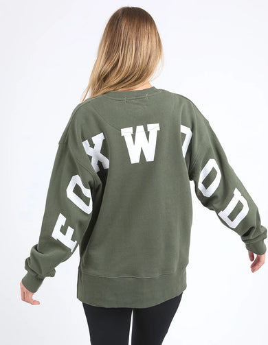 Person wearing a green sweatshirt with white text on a white background