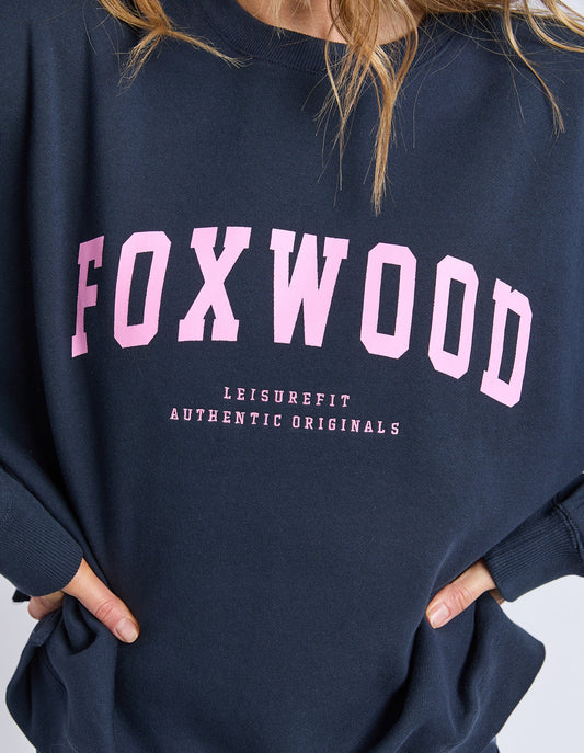 Navy sweatshirt with 'FOXWOOD' printed in pink on a white background