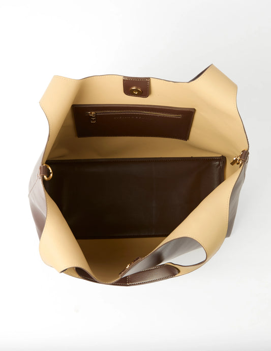 Open beige handbag with brown interior on a white background