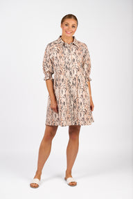 Woman wearing a patterned dress on a white background