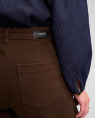 Brown pants with a visible brand label on a neutral background