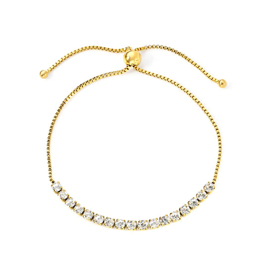 Gold bracelet with clear stones on a white background