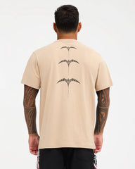 pale khaki tee with chest logo and design down the back