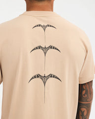 pale khaki tee with chest logo and design down the back
