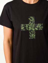 Black t-shirt with a green floral cross design on a white background
