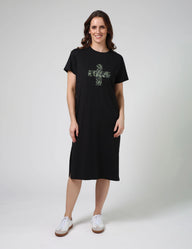 Woman wearing a black t-shirt dress with a floral design on a white background