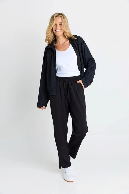 Woman wearing a black outfit with a white background