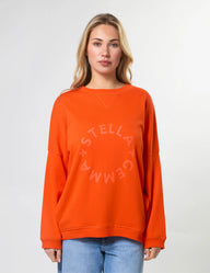 Woman wearing an orange sweatshirt with a logo on a white background