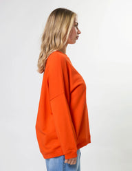 Person wearing an orange sweatshirt on a white background
