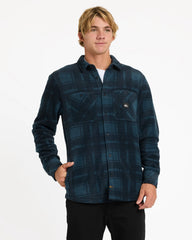 Man wearing a blue plaid shirt on a white background