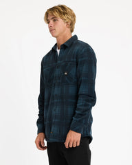 Man wearing a blue plaid shirt on a white background