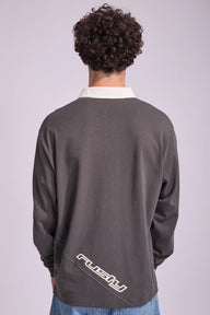 Person wearing a gray jacket with 'Rusty' branding on the back against a white background