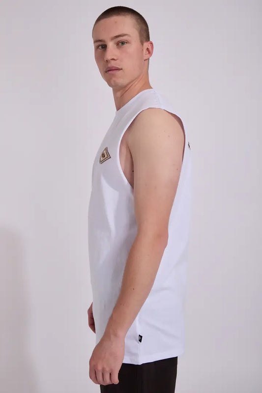 Person wearing a white sleeveless shirt with a logo on a plain background