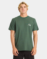 Man wearing a green t-shirt with a logo on a white background