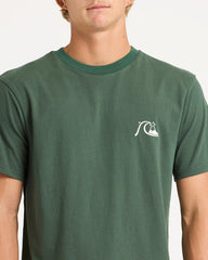 Green t-shirt with a logo worn by a person on a light gray background