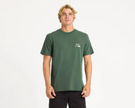 Man wearing a green t-shirt with a logo and black pants on a white background