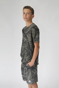 Person wearing a camouflage t-shirt and shorts on a white background