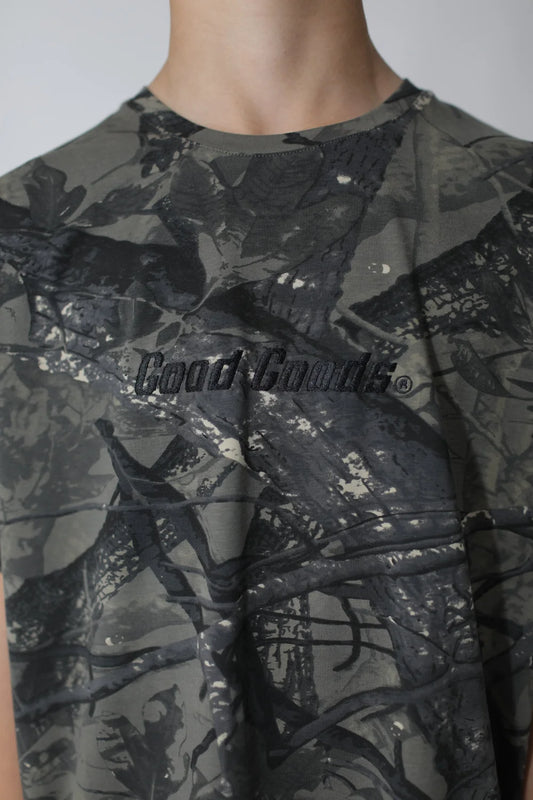 camouflage-patterned shirt with 'Good Goods' logo on a plain background