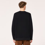 Person wearing a black sweater on a plain background