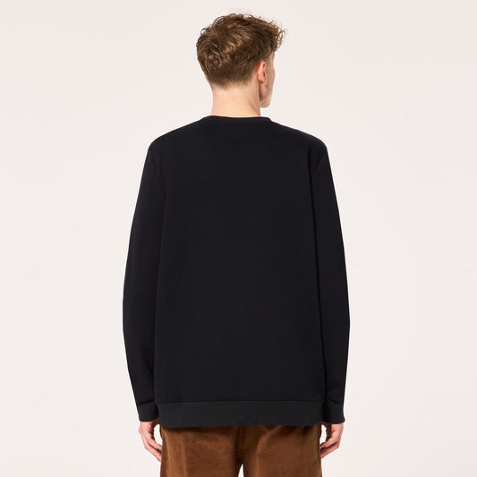 Person wearing a black sweater on a plain background
