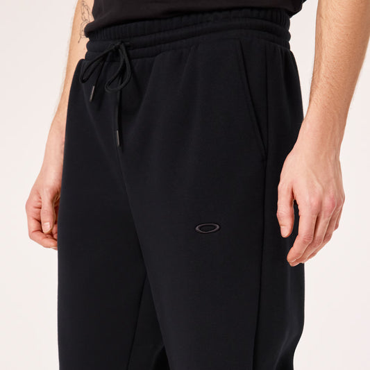 Black pants with a brand logo on a light background