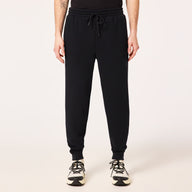 Person wearing black jogger pants on a white background