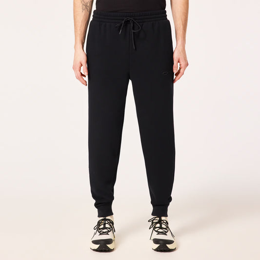 Person wearing black jogger pants on a white background