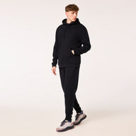 Person wearing a black tracksuit on a white background