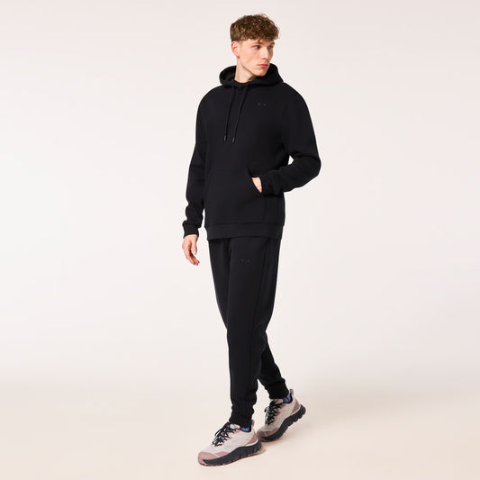 Person wearing a black tracksuit on a white background