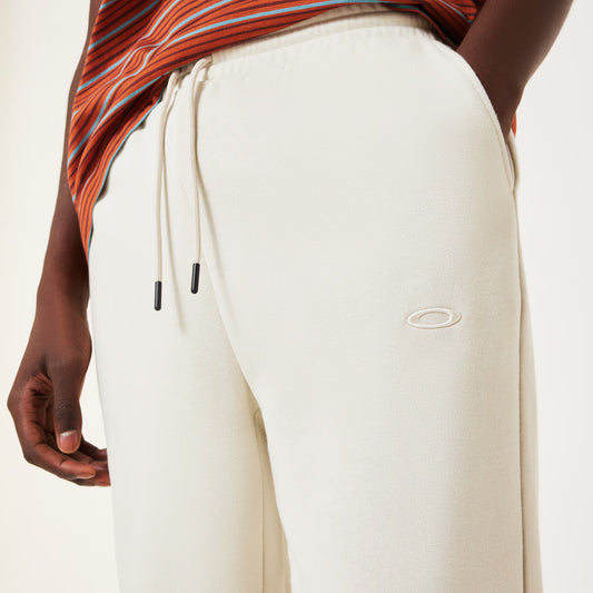 White jogger pants with a brand logo on a neutral background