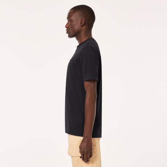 Man wearing a black t-shirt and beige pants on a white background
