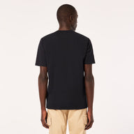 Man wearing a black t-shirt and beige pants on a white background