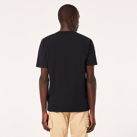 Man wearing a black t-shirt and beige pants on a white background