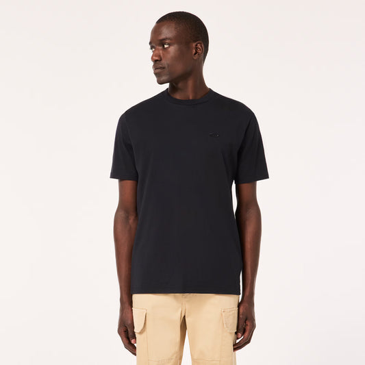 Man wearing a black t-shirt and beige pants on a white background