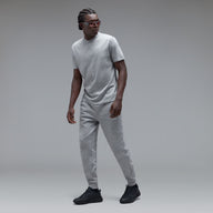 Man wearing a grey t-shirt on a grey background