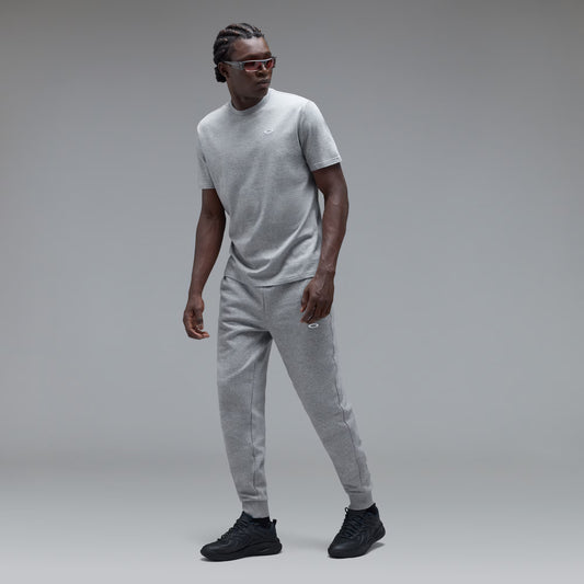 Man wearing a grey t-shirt on a grey background
