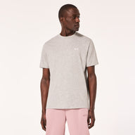 Man wearing a gray t-shirt and pink pants on a white background