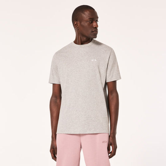 Man wearing a gray t-shirt and pink pants on a white background